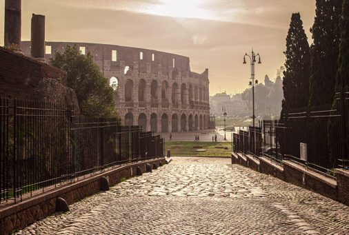 Colosseum sunrise view from an ancient Roman street